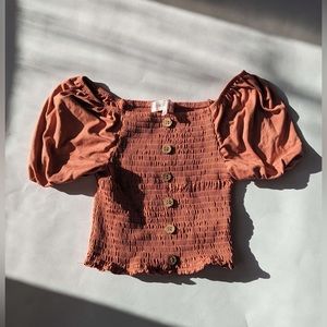 stretchy pink textured shirt with puff sleeves